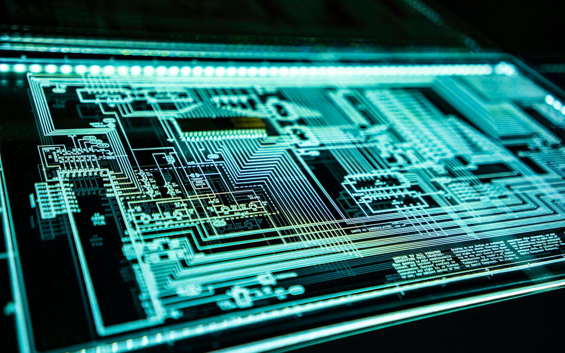 Close-up of a circuit board lit in blue